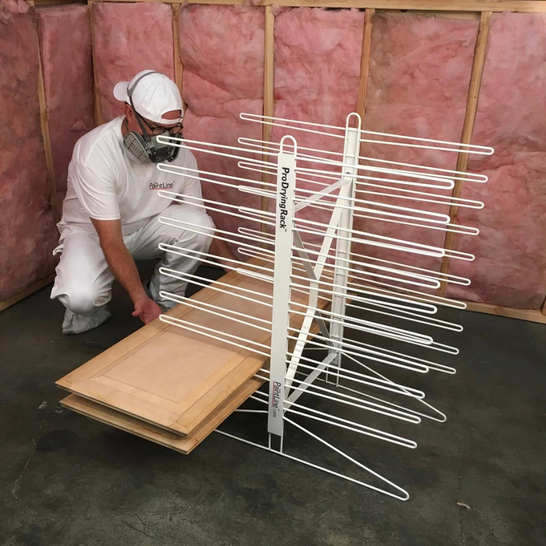 Men drying doors on cabinet door drying on Paint Drying Rack